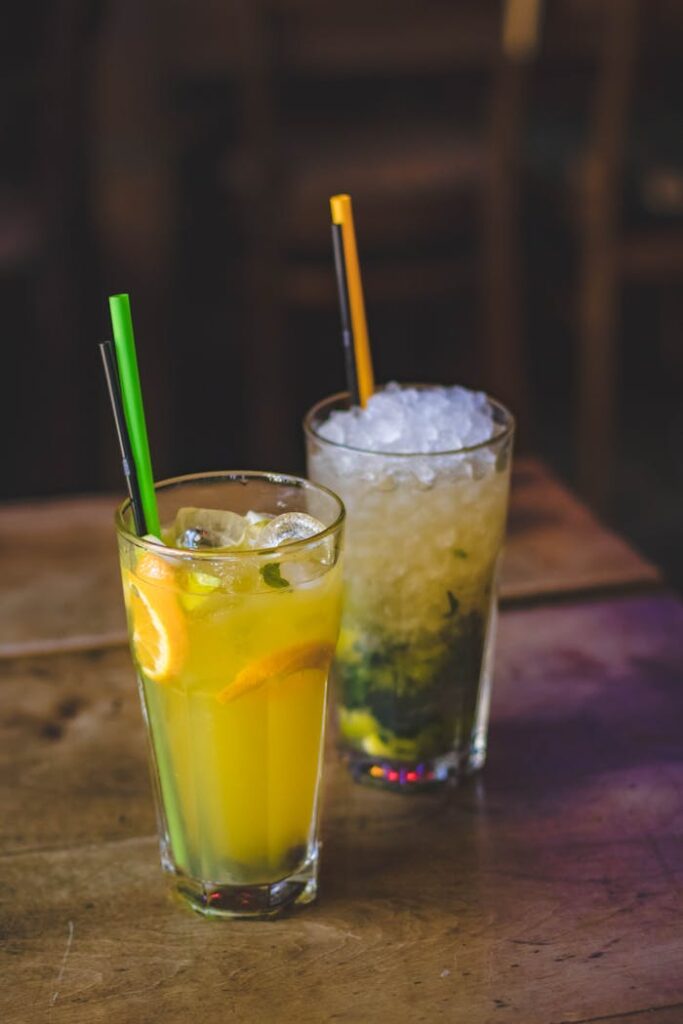 Two Cup of Juice on Brown Wooden Table Top